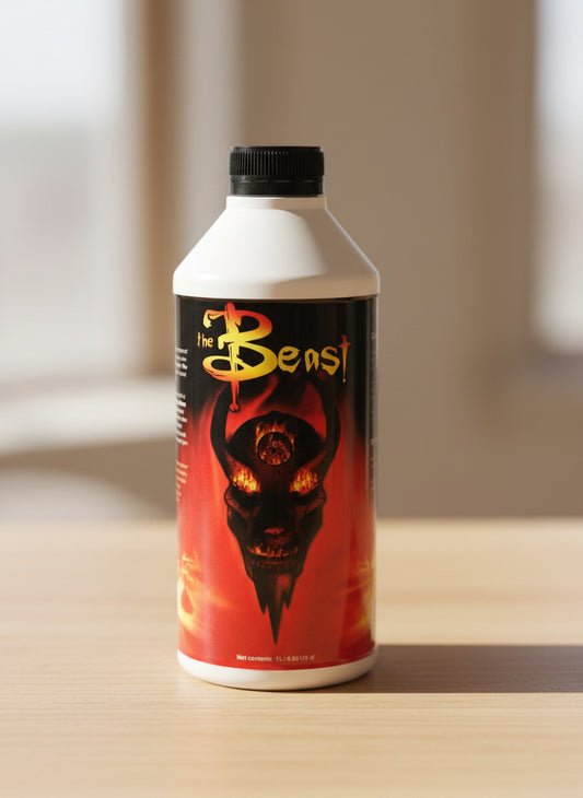 Bottle of 'The Beast' supplement with a red and black label on a metallic surface.